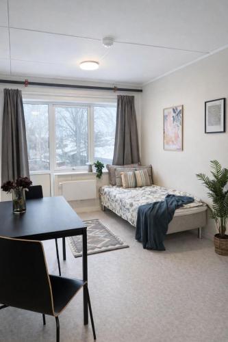 a bedroom with a bed and a table and a table sidx sidx sidx at Rygge Apartments in Moss