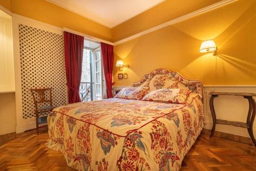 a bedroom with a bed in a room with a window at Casa Orta appartamento con vista lago in Orta San Giulio