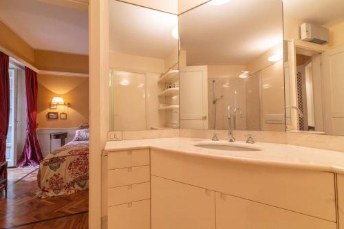 a bathroom with a sink and a bed in a room at Casa Orta appartamento con vista lago in Orta San Giulio