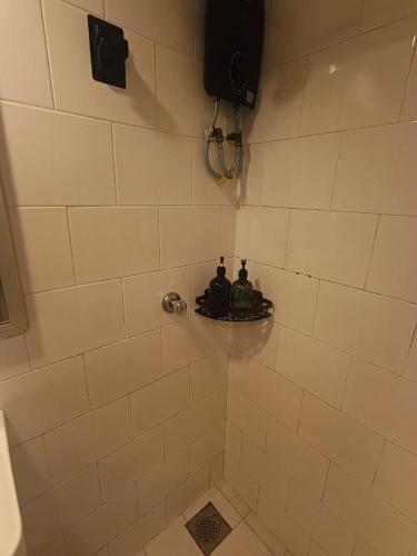 two people sitting on a shelf in a shower at Olio CoLiving Pudu Kuala Lumpur in Kuala Lumpur
