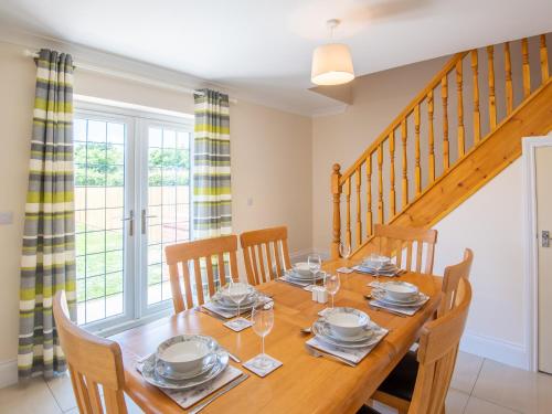 a dining room with a wooden table and chairs at Dawson Park 8 - Uk12667 in Mablethorpe