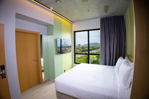 a bedroom with a large bed and a window at Liwe Hotels in Penha