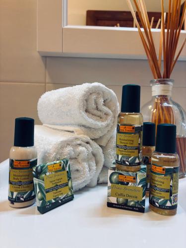 a bathroom counter with bottles of essential oils and towels at Borgo San Benedetto in Montaione