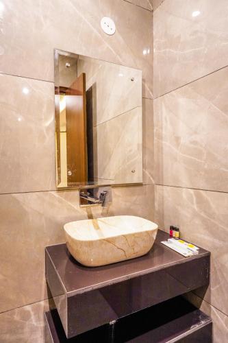 a bathroom with a sink and a mirror at Hotel American inn in Nakodar