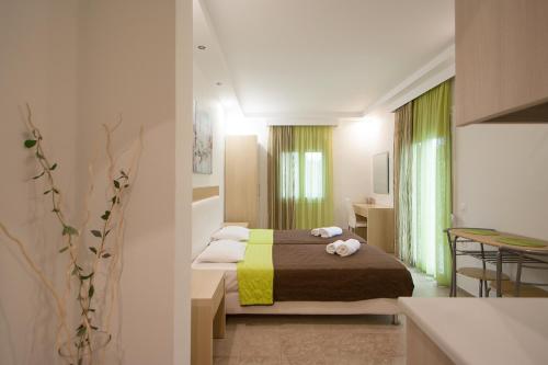 a hotel room with a bed and a kitchen at Villa ALEXIS in Koukounaries