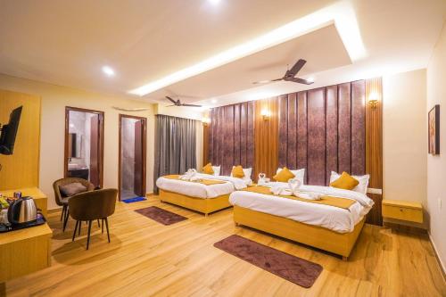 a hotel room with two beds and a desk at Hotel American inn in Nakodar