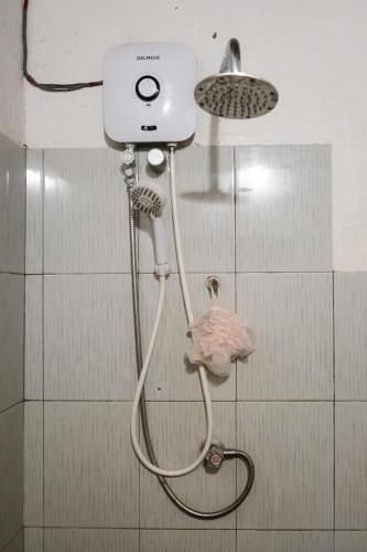 a shower in a bathroom with a shower head at Kon Tree Shade in Dambulla