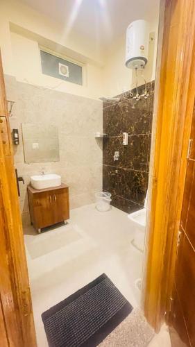 a bathroom with a sink and a toilet and a shower at Hotel Blue Moon in Rishīkesh