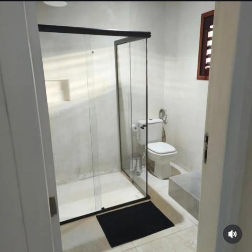 a glass shower in a bathroom with a toilet at Casa Sol e mar Uruaú in Beberibe