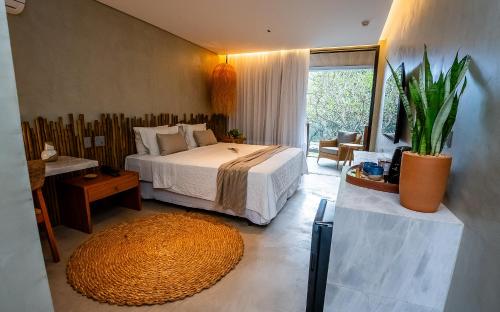 a bedroom with a bed and a large rug at Hotel Pontal de Ubu in Anchieta