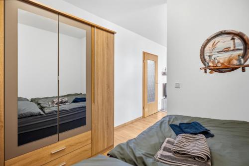 a bedroom with a glass cabinet with a bed in it at Top Unterkunft direkt vor Leipzig in Schkeuditz