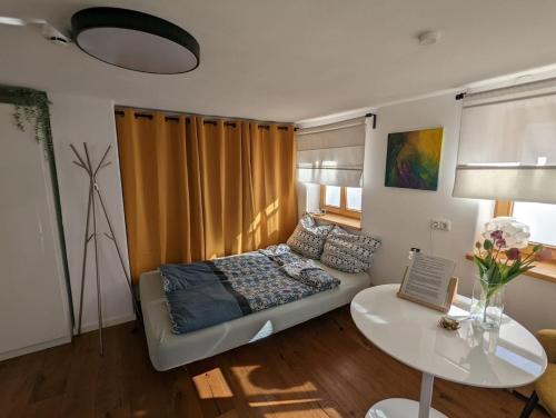 a living room with a couch and a table at Gemütliches, helles, voll ausgestattetes Apartment mit Terrasse in Waal