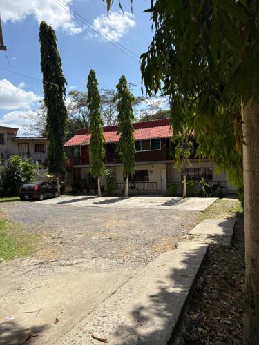 a building with a parking lot in front of it at Residencial De Rosas in Santiago
