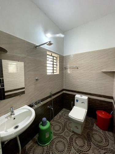 a bathroom with a sink and a toilet at Mango tree room stay in Gokarna