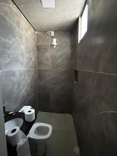 a small bathroom with a toilet and a sink at Sobrado Oliveira in Goiânia