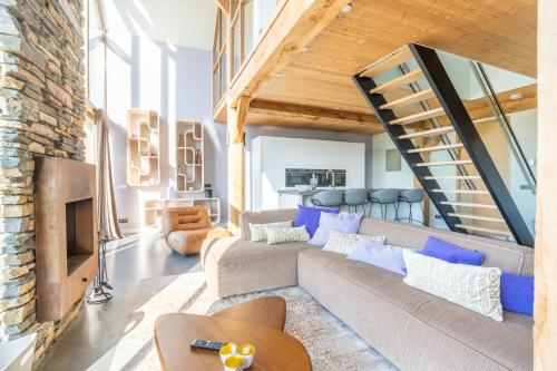 a living room with a couch and a staircase at Buytenplaats Villa 189 in De Koog