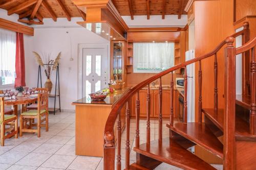 a kitchen and dining room with a spiral staircase at VILLA MITZELOS in Skiathos