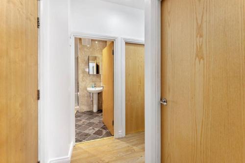 an open door to a bathroom with a sink at Newcastle City Centre Apartment in Newcastle upon Tyne