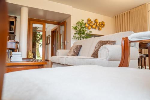 a living room with two white couches in a room at Quinta das Mineirinhas in Vila Nova de Cerveira