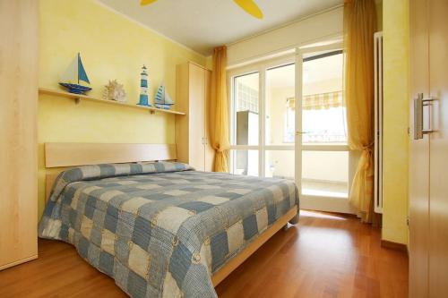 a bedroom with a bed and a large window at WI-RO Risorgimento,9 - La Perla di Andora in Marina di Andora