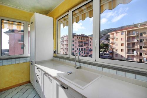 a kitchen with a sink and two windows at WI-RO Risorgimento,9 - La Perla di Andora in Marina di Andora