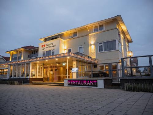 a large building with a sign in front of it at Heeren van Noortwyck in Noordwijk aan Zee