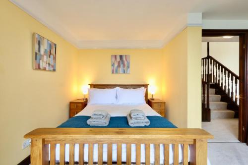 a bedroom with a bed with two towels on it at Great Edge in Luddenden Foot
