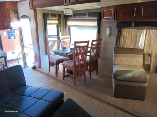 a living room with a table and chairs and a couch at Mountain Camper at Howland's Hideout in Sampson