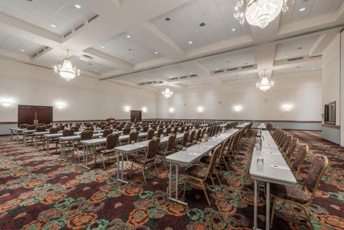a large room with tables and chairs in it at Ramada by Wyndham State College Hotel & Conference Center in State College