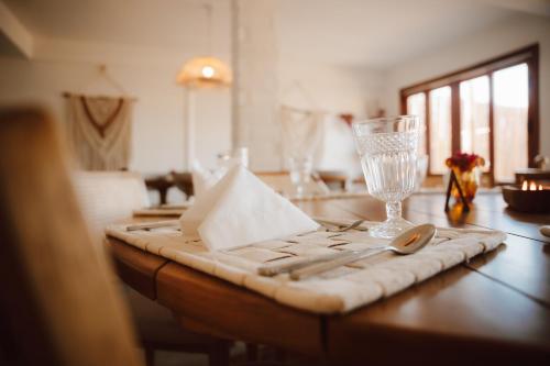 a table with a napkin and a glass on it at Ankura Preá Spa & Boutique Hotel in Cruz