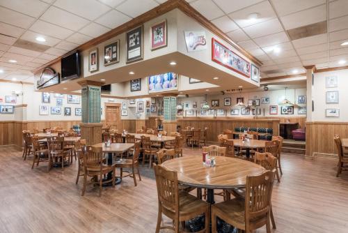 a dining room with wooden tables and chairs at Ramada by Wyndham State College Hotel & Conference Center in State College