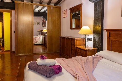 a bedroom with a bed and a mirror at La casona de la alberca in La Alberca