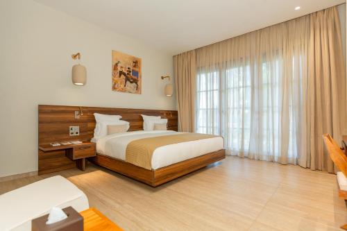 Llit o llits en una habitació de Native Hotels Ouidah