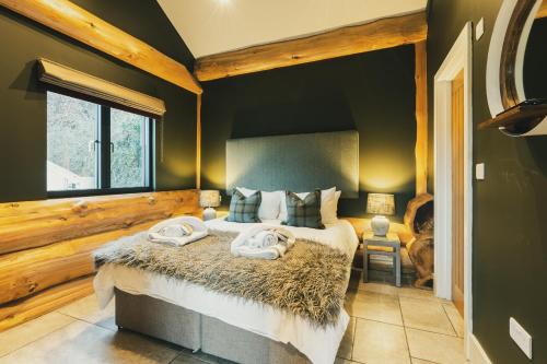 a bedroom with a large bed with towels on it at Bears Den in Ilkley