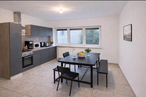 a kitchen with a table and chairs in a room at Monteurzimmer Saarland in Merchweiler