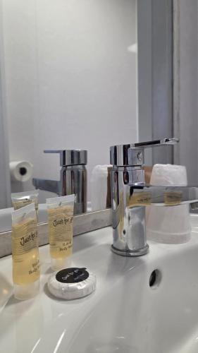 a bathroom counter with a sink with a mirror at The Devonshire House Hotel-Free Parking in Liverpool