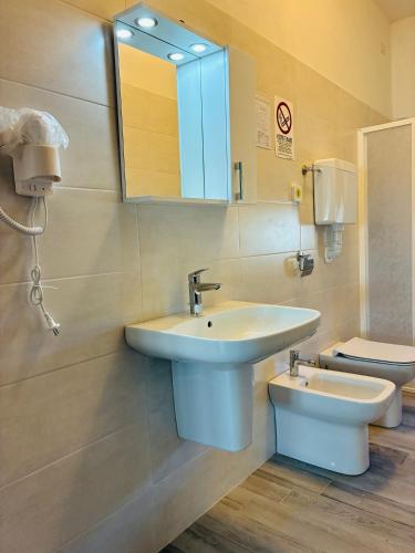ein Badezimmer mit Waschbecken und Toilette in der Unterkunft Hotel Riccò in Bagnolo San Vito