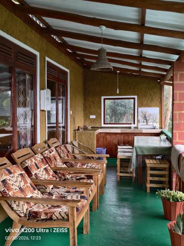 a room with wooden tables and chairs and a bar at NETHSARA cottage in Ella