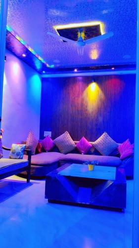 a living room with a couch and purple lights at Lonavala Golden Bird 3 bhk villa in Malavli