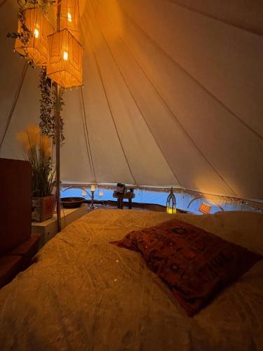 a bedroom with a bed with a tent at Vista Vibes Glamping in Grillby