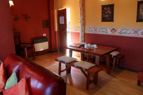 a living room with a table and a couch at Quinua Boutique Apartments in Cusco