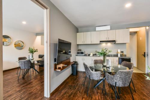 a kitchen and dining room with a table and chairs at The Sterling Condesa in Mexico City