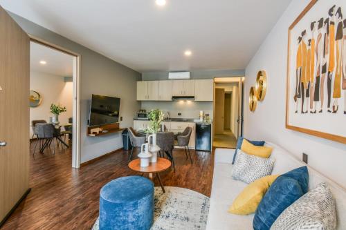 a living room with a couch and a table at The Sterling Condesa in Mexico City