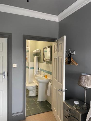 a bathroom with a sink and a toilet at The White House Hotel in Newquay