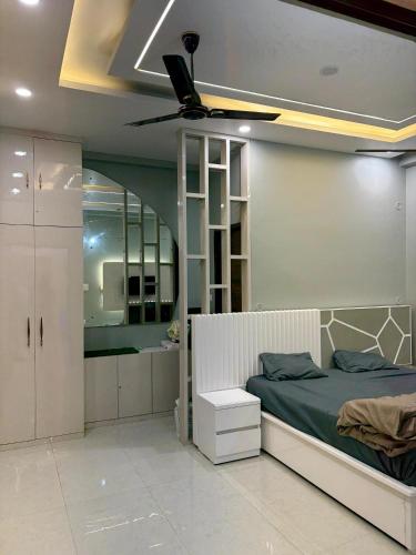 a bedroom with a bed and a ceiling fan at Amigos Farm in Lucknow