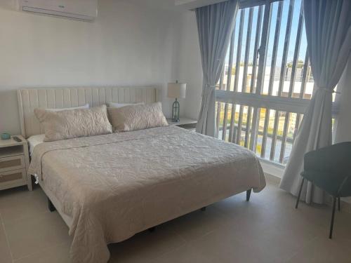 a bedroom with a bed and a large window at Damani Modern Pool Villa Escape in Punta Cana