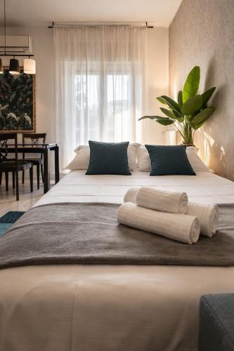 a bedroom with a large bed with towels on it at Ca' De Amicis Rho Fiera Milano - Private parking - Self check in in Rho