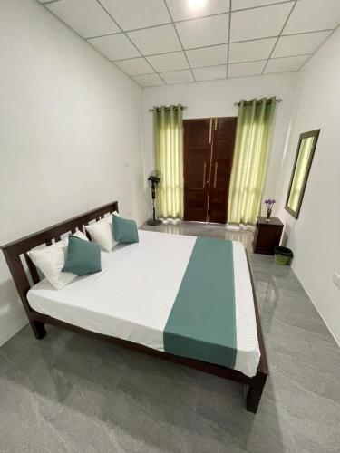 a bedroom with a large bed in a room at Diyathna Nuwarawewa in Anuradhapura