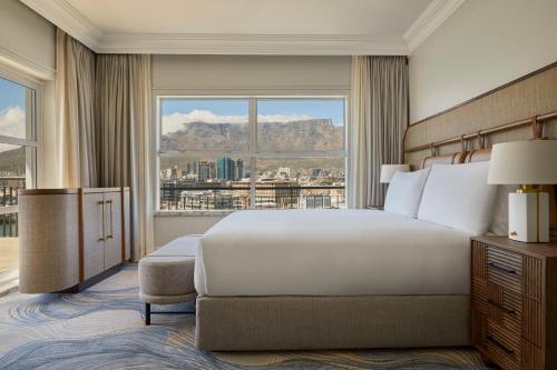 a bedroom with a large bed and a large window at InterContinental Table Bay Cape Town by IHG in Cape Town