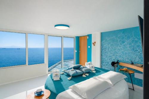 a bedroom with a bed with a view of the ocean at Laguna Blu in Vietri sul Mare